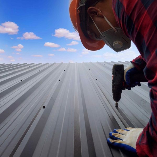 roofer-construction-worker-install-new-roof-roofing-tools-electric-drill-used-new-roofs-with-metal-sheet